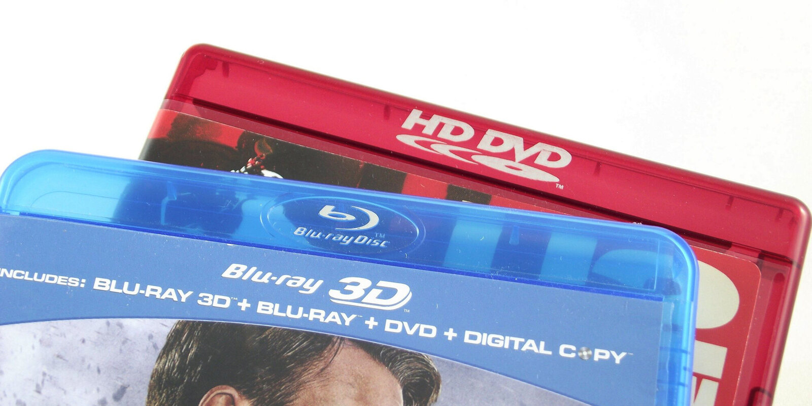 The red HD DVD case next to the blue Blu-ray one: the two formats as they sat on shop shelves in 2007.