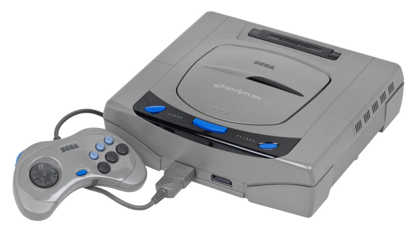 The first Japanese Sega Saturn, grey with the blue-and-white buttons and the oval-button controller, as sold from 22 November 1994.